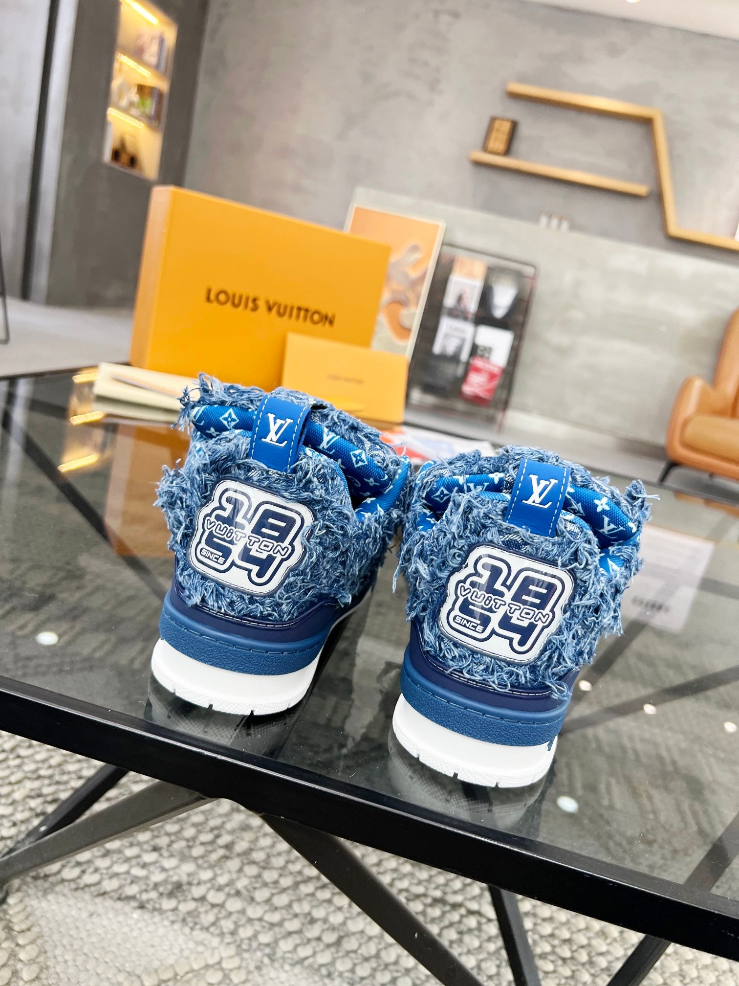 Distressed Denim Luxury Sneakers with High-End Detailing and Signature Blue Sole