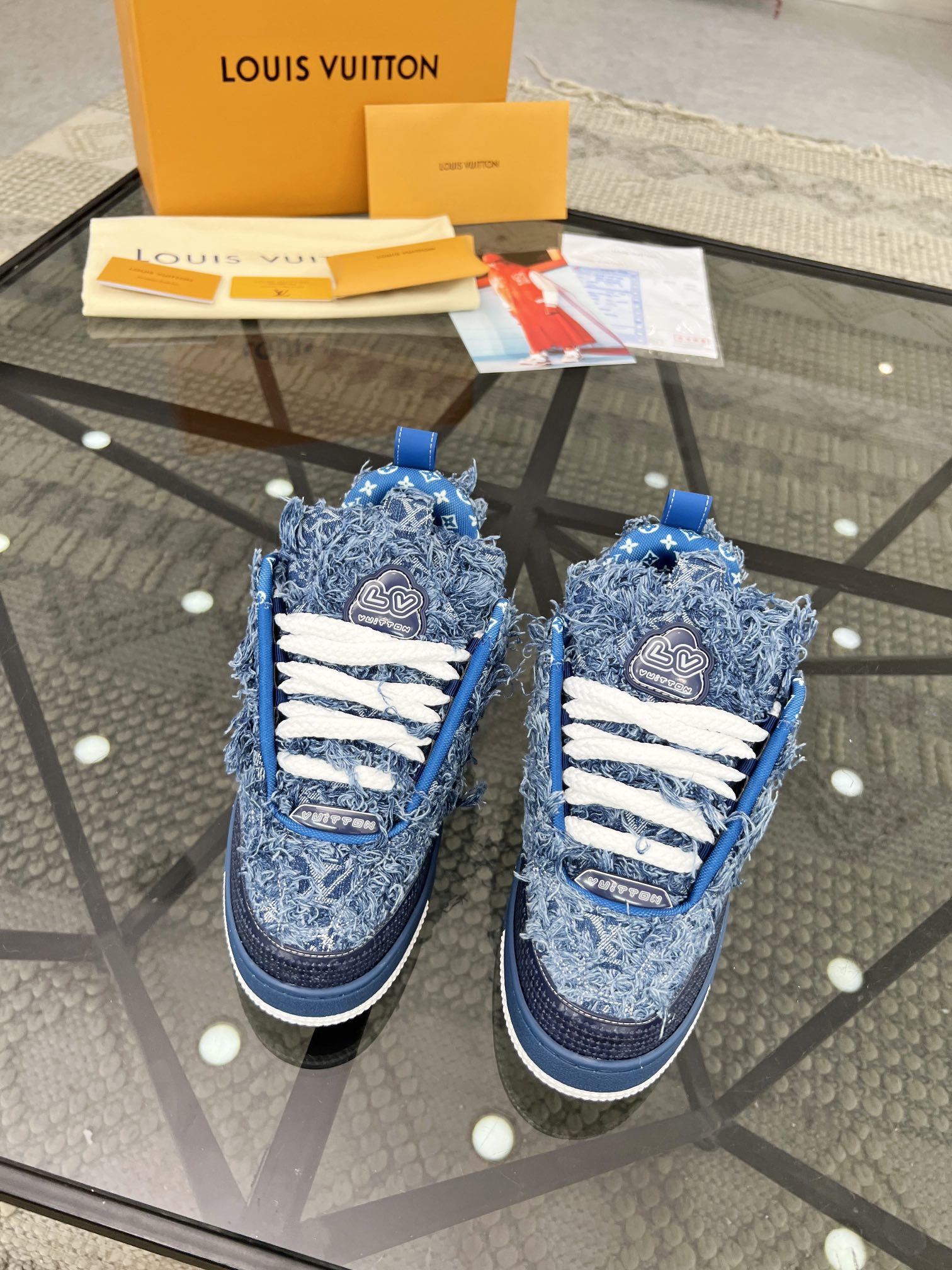 Distressed Denim Luxury Sneakers with High-End Detailing and Signature Blue Sole