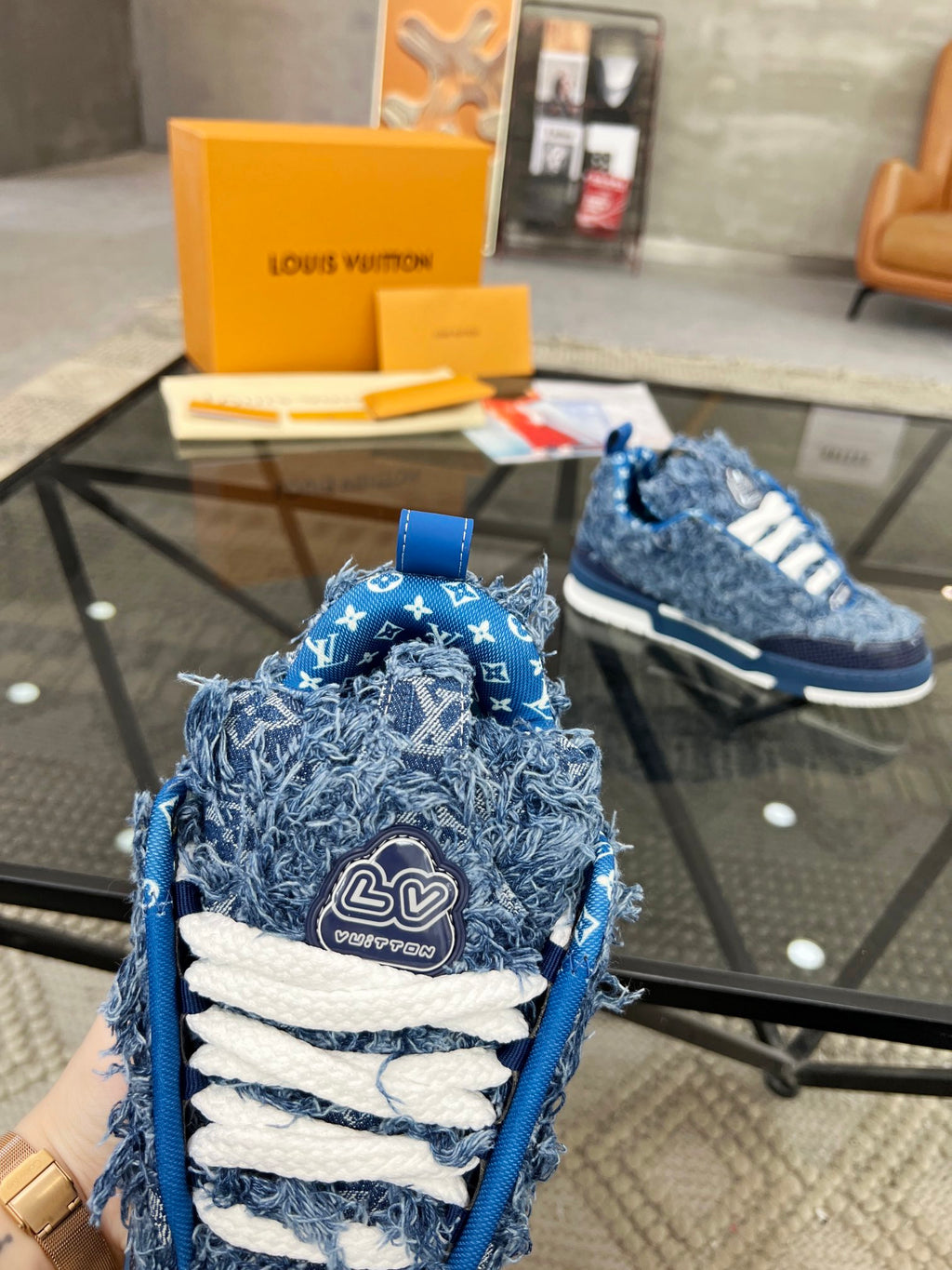 Distressed Denim Luxury Sneakers with High-End Detailing and Signature Blue Sole