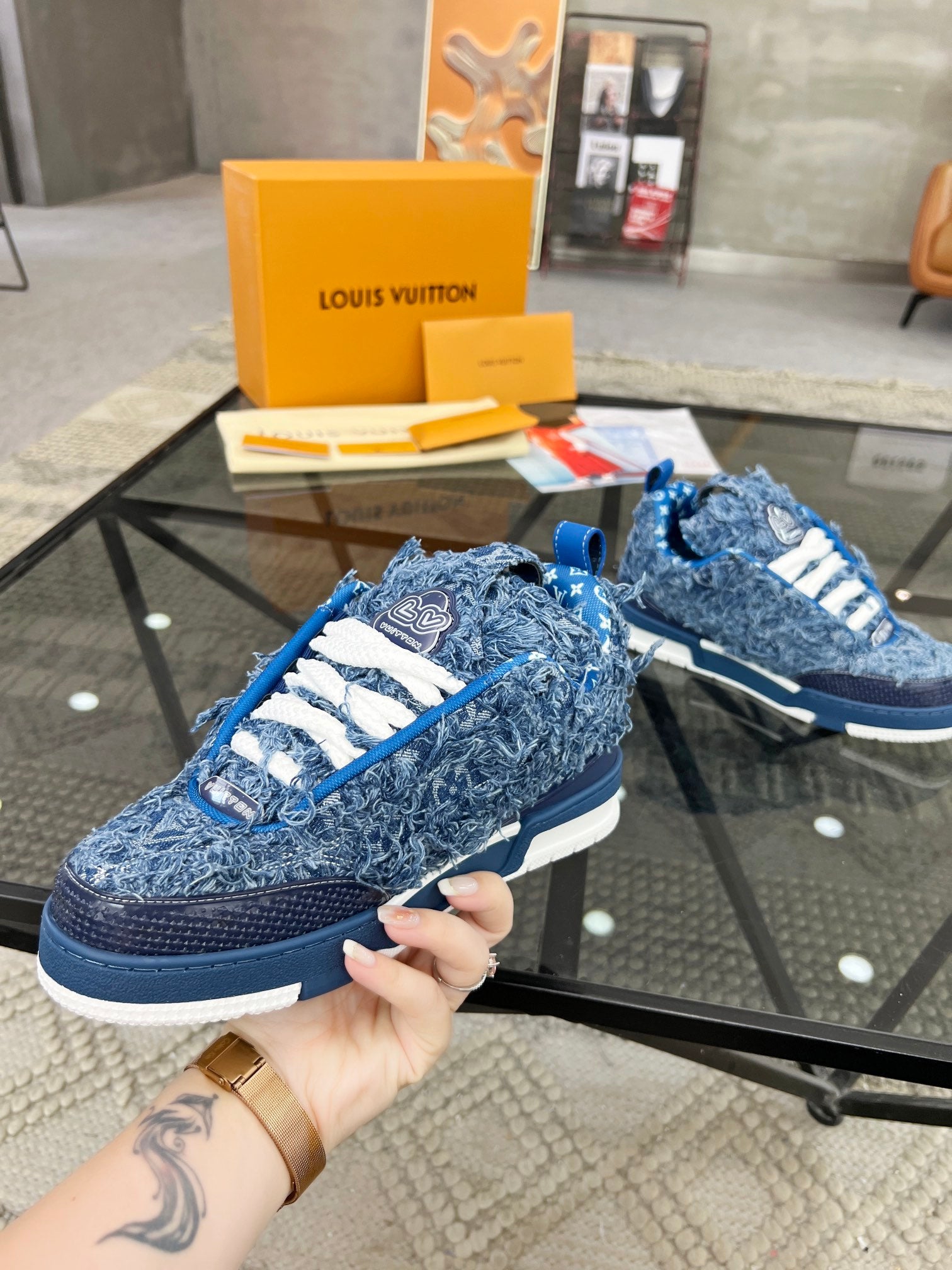 Distressed Denim Luxury Sneakers with High-End Detailing and Signature Blue Sole