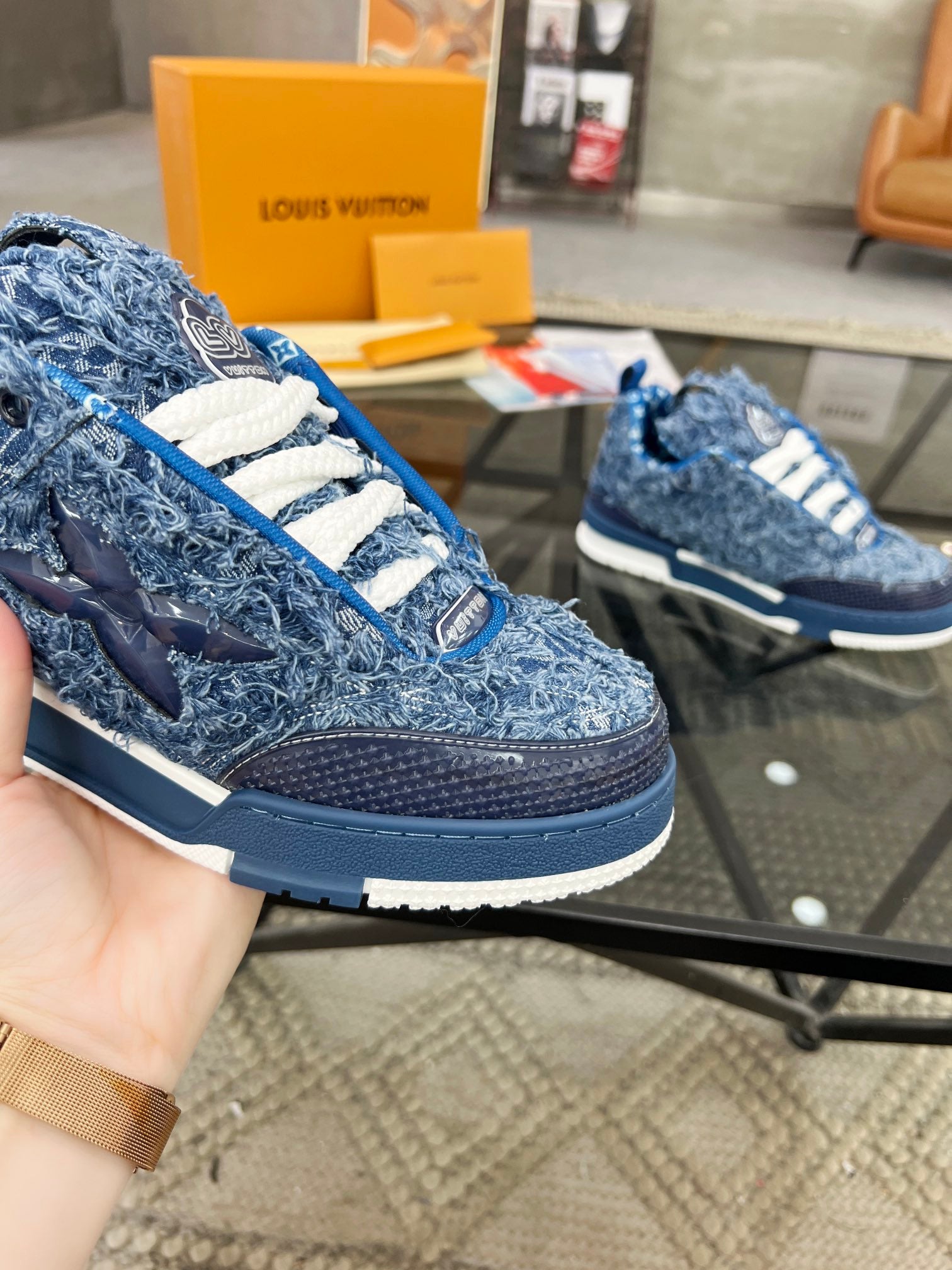 Distressed Denim Luxury Sneakers with High-End Detailing and Signature Blue Sole